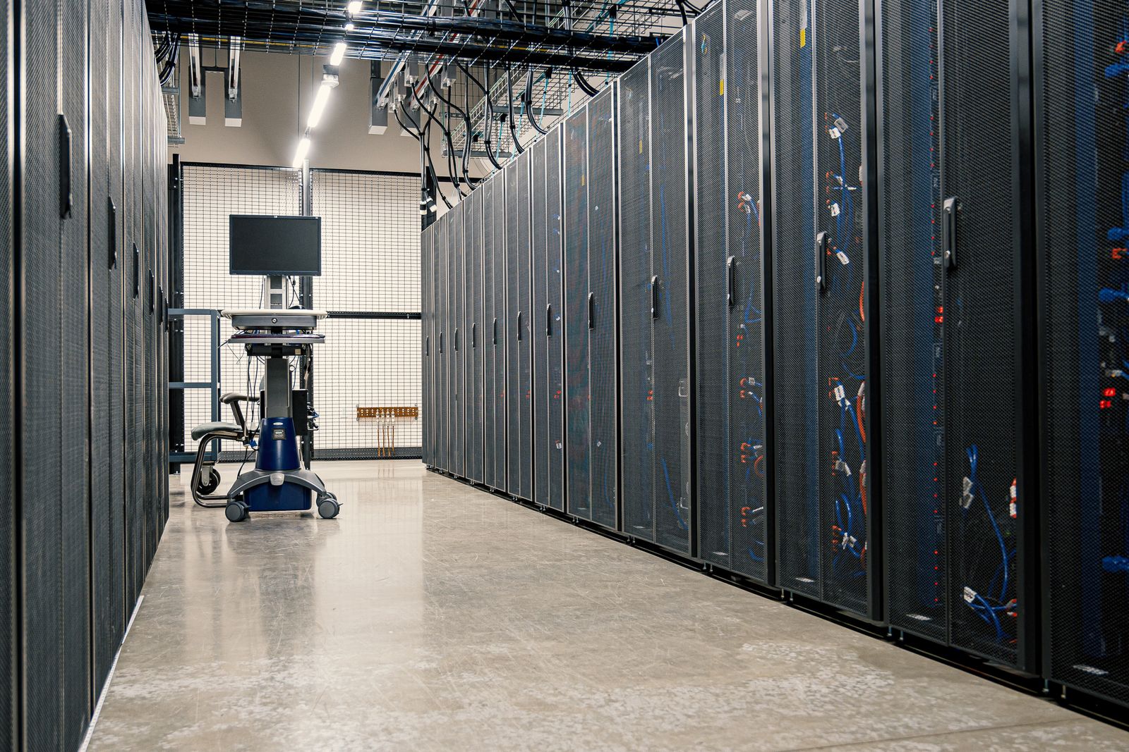 Rows of server racks in a data center aisle